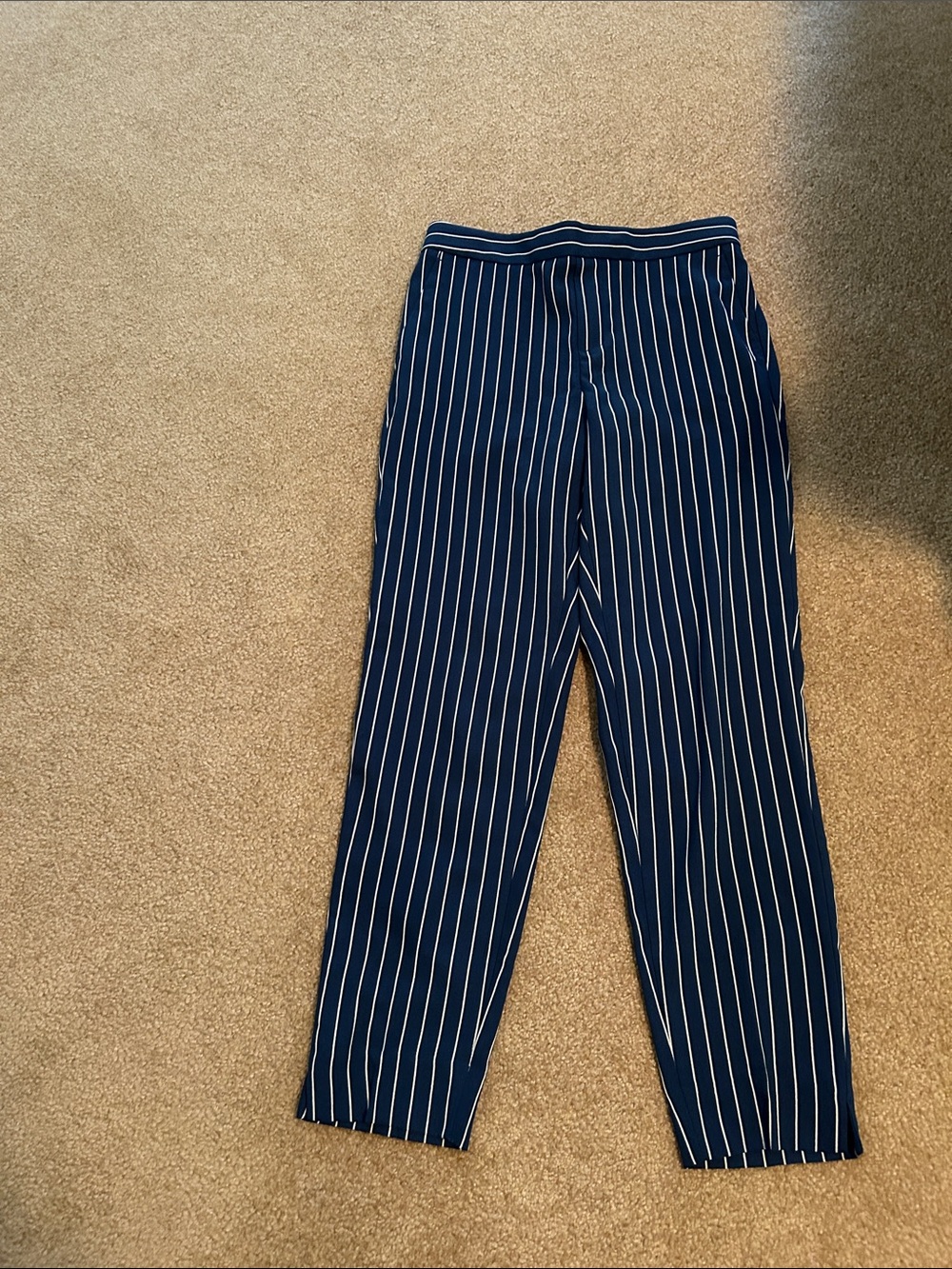 Straight leg trousers with side and pack pockets. Elastic waist in back